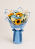 A wrapped flower bouquet featuring yellow sunflowers, white roses, and blue flowers, wrapped in light blue paper with a matching blue ribbon bow, set against a plain light beige background.
