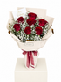 A bouquet of seven red roses and white baby&