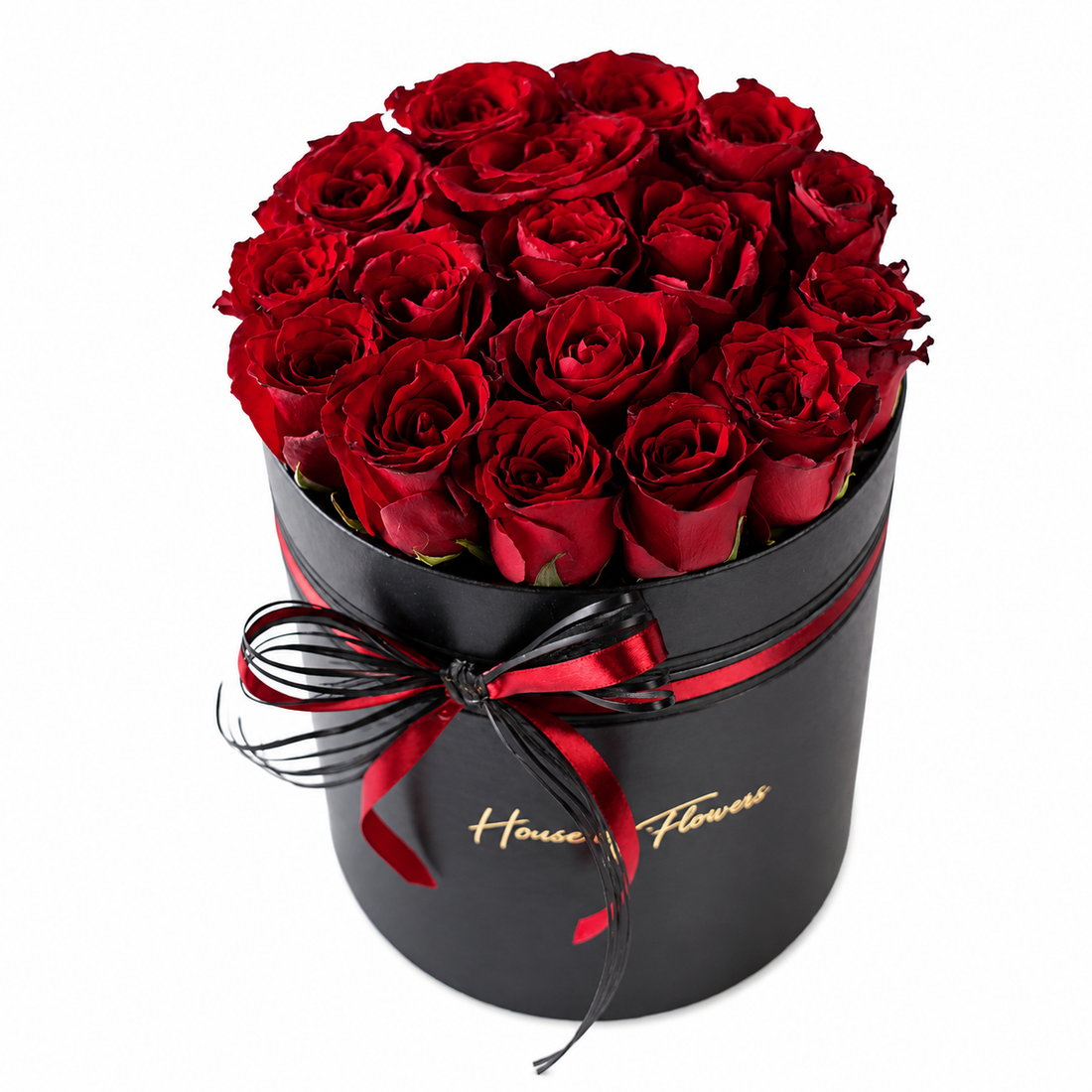 A round black gift box filled with red roses, tied with a black and red ribbon and featuring gold &