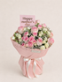 A pink and white rose bouquet wrapped in pink paper with a white ribbon, featuring a pink card that reads &