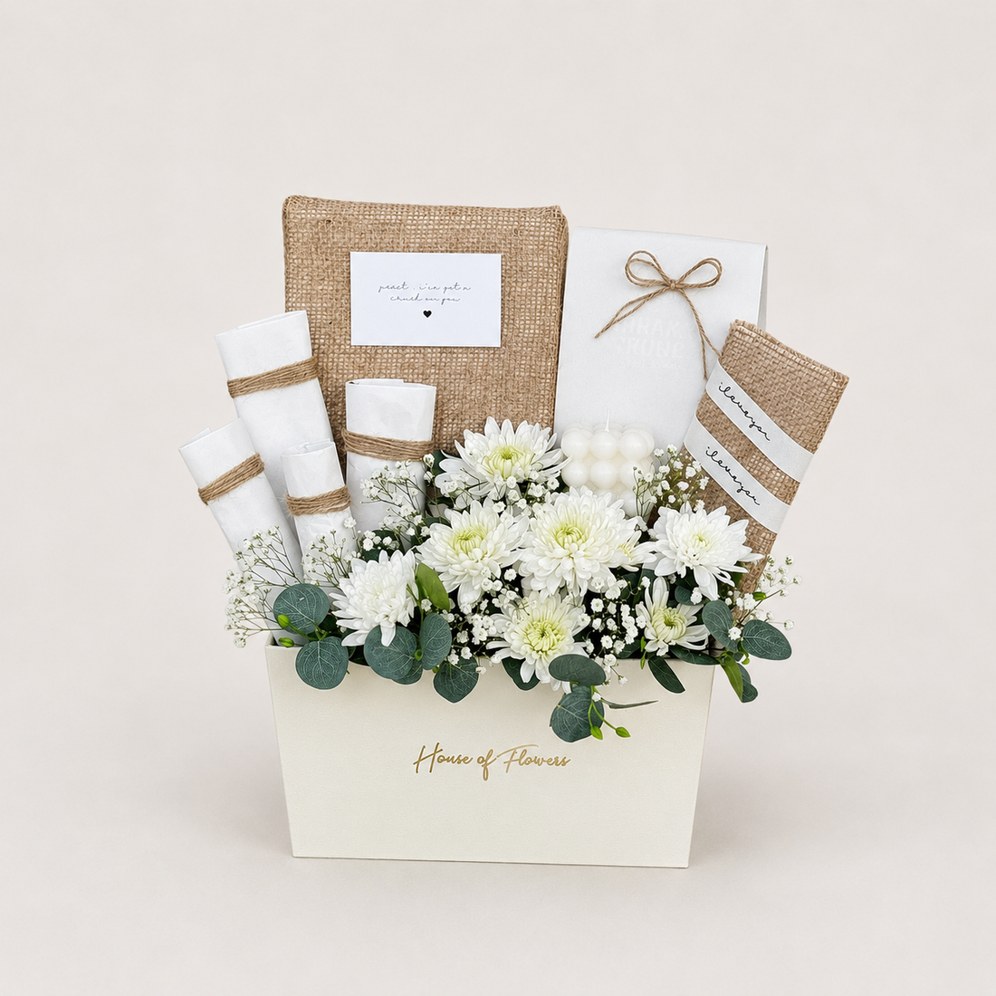 A floral gift basket arrangement from House of Flowers, featuring white chrysanthemums, green eucalyptus, white baby&