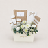 A floral gift basket arrangement from House of Flowers, featuring white chrysanthemums, green eucalyptus, white baby&