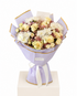 A floral bouquet wrapped in light lavender paper with gold trim and a white ribbon, displayed on a white pedestal against a white background. The bouquet contains cream and pale yellow roses, white chrysanthemums, and small pink filler flowers.