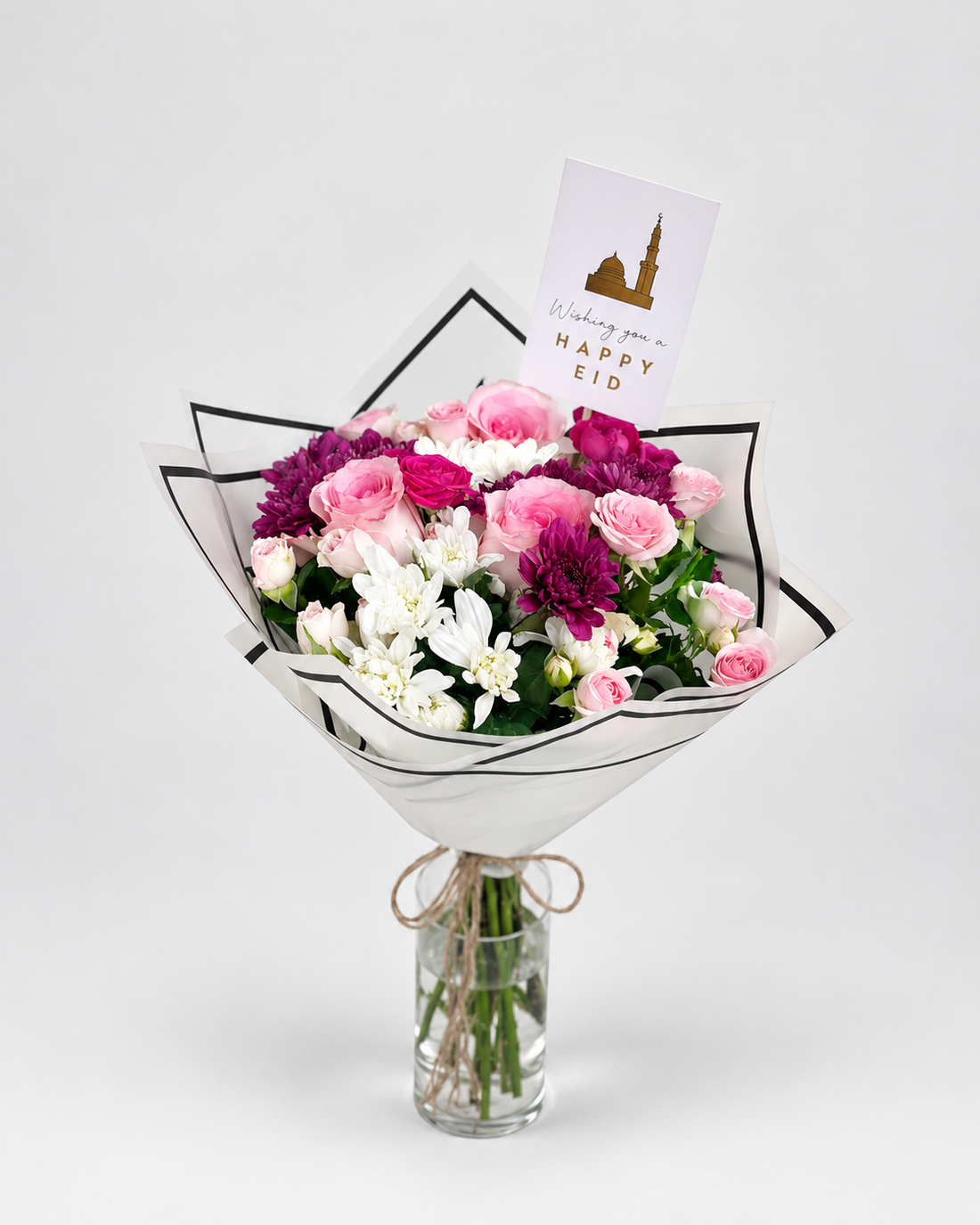 Bouquet of white flowers in a teal wrap on a gray surface with &