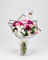 Bouquet of white flowers in a teal wrap on a gray surface with &
