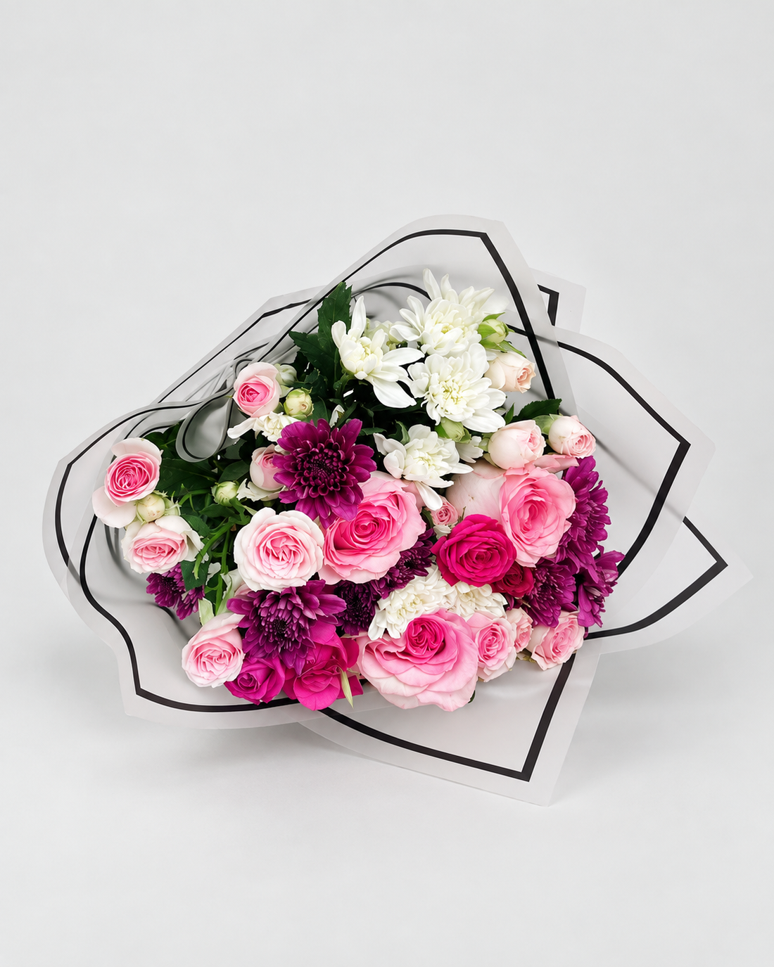 Bouquet of white flowers in a teal wrap on a gray surface with &